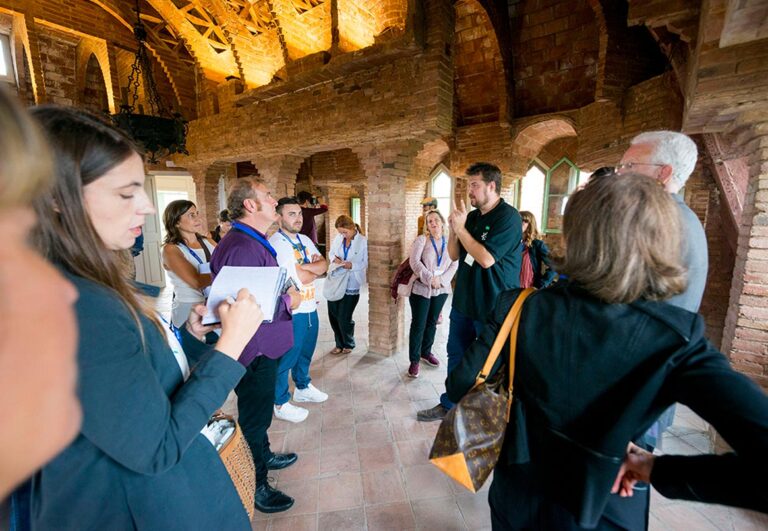 Group of visitors on a guided tour inside Torre Bellesguard during GWC 2016 Barcelona, with a guide explaining Gaudí’s architectural details